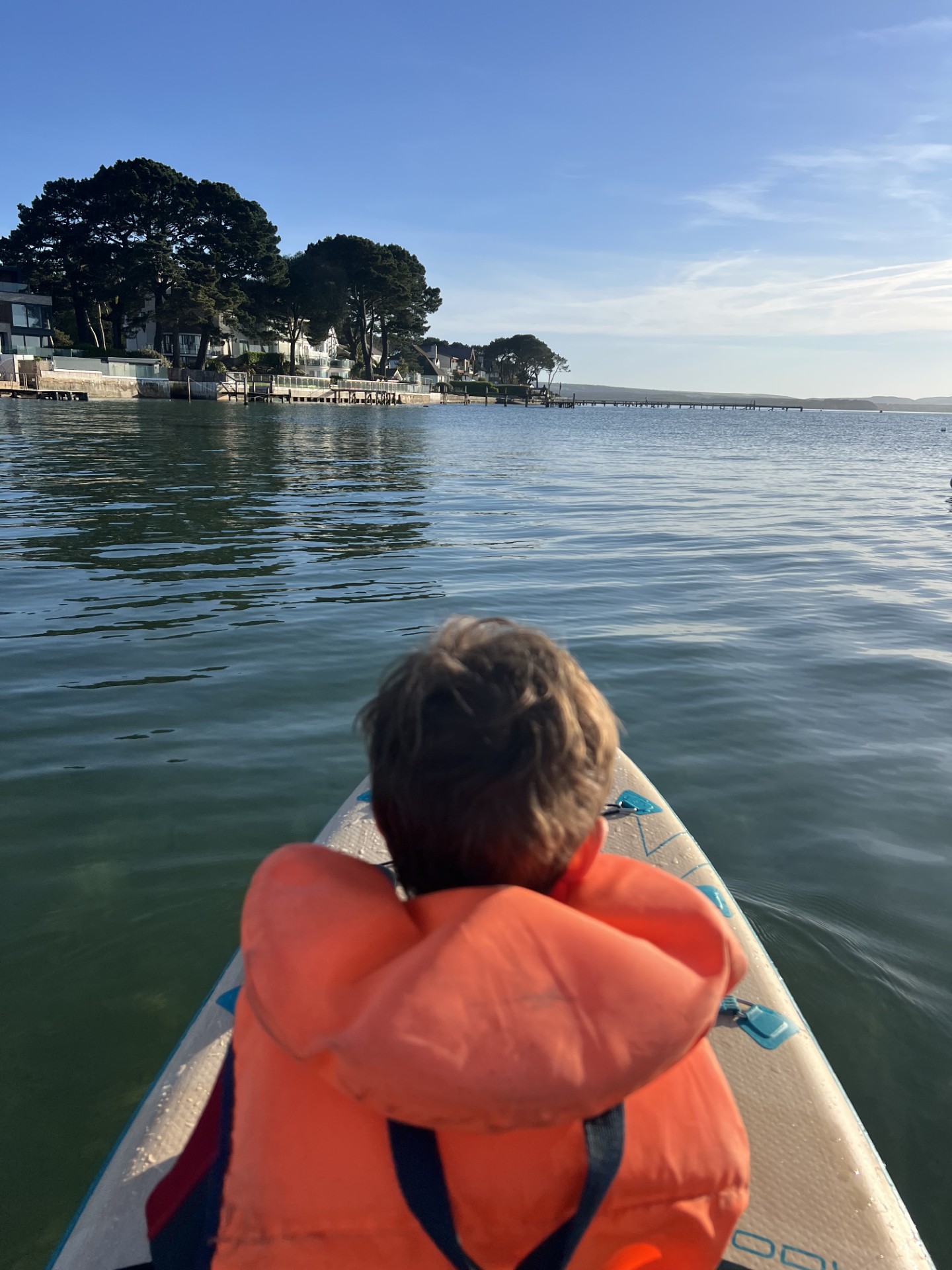 Beginner finding their balance while paddleboarding in the Lake District